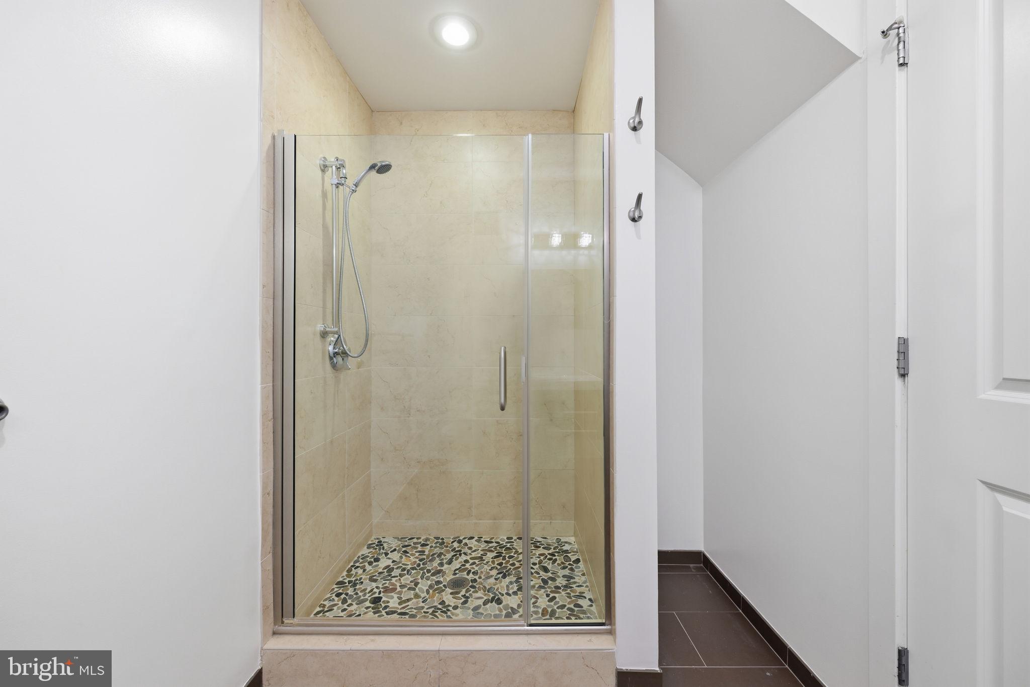 401 15th Street Southeast, Unit 401 Washington, DC 20003 - Photo 11 of 20 a bathroom with a glass shower door