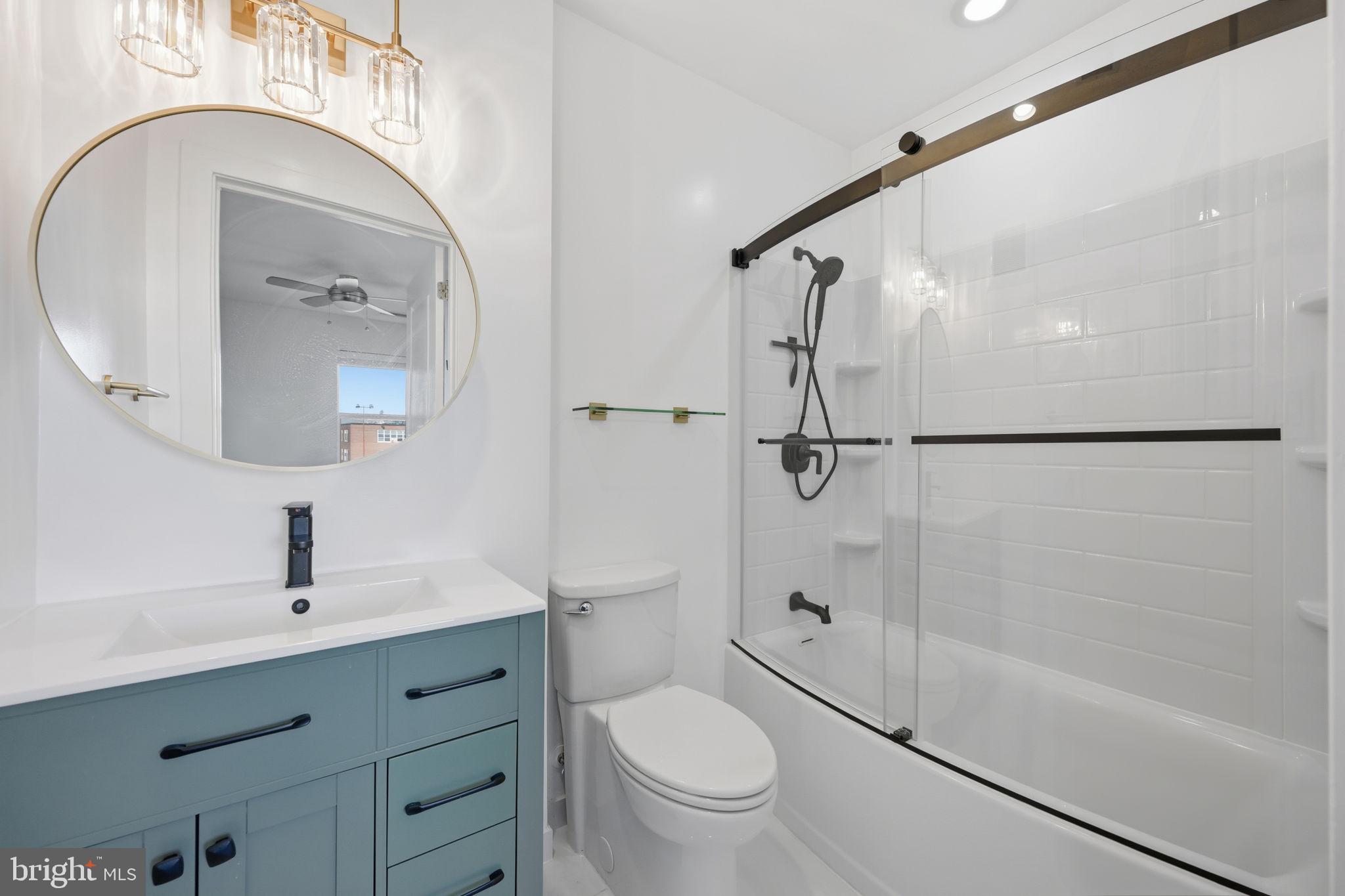 401 15th Street Southeast, Unit 401 Washington, DC 20003 - Photo 14 of 20 a bathroom with a shower a sink mirror vanity and toilet