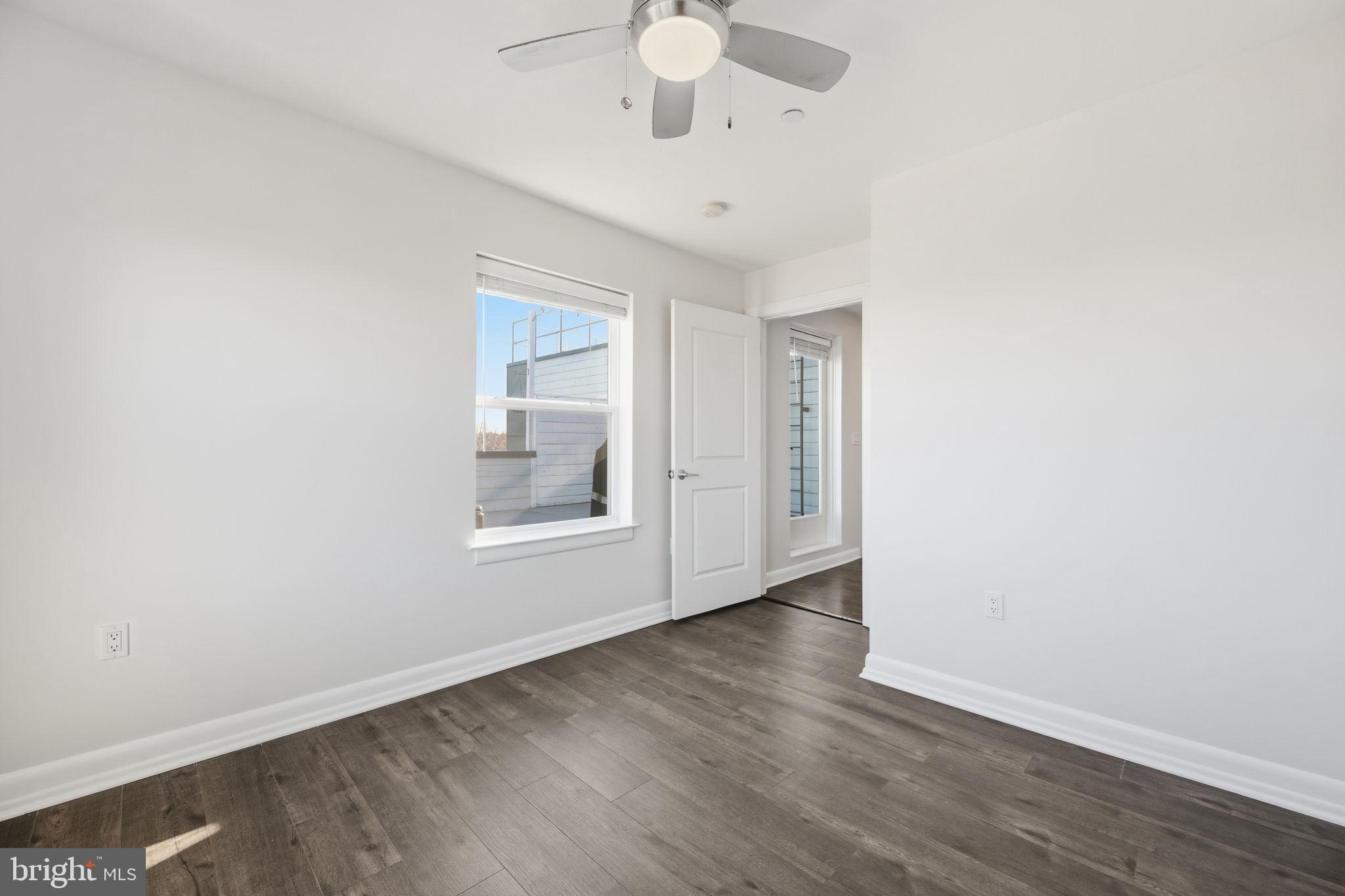 401 15th Street Southeast, Unit 401 Washington, DC 20003 - Photo 10 of 20 an empty room with wooden floor fan and window