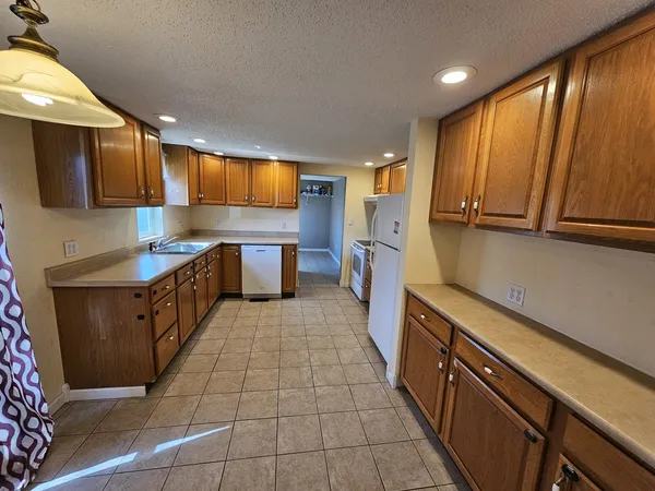 a kitchen with stainless steel appliances a sink stove and cabinets