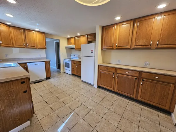 a kitchen with a sink cabinets and window