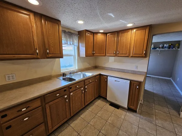 a kitchen with wooden cabinets and a sink
