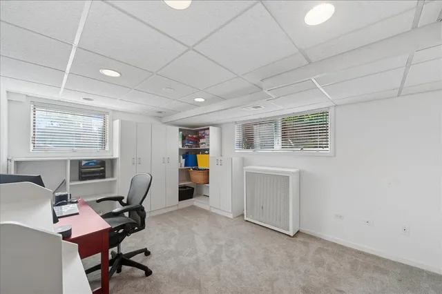 a backyard of a house with plants and wooden fence