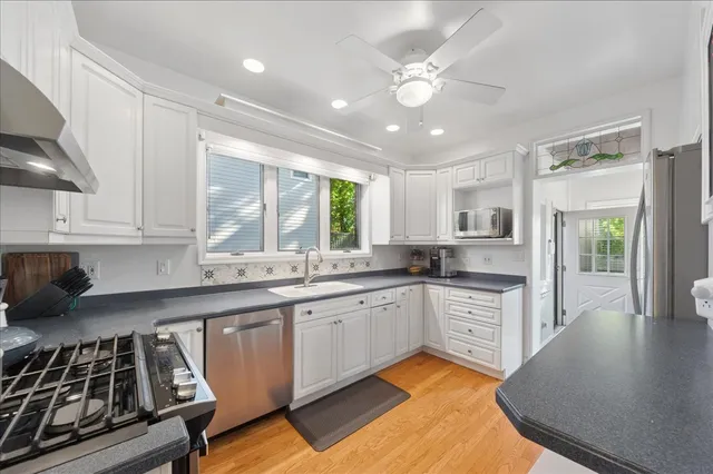 a kitchen with a sink stove and cabinets