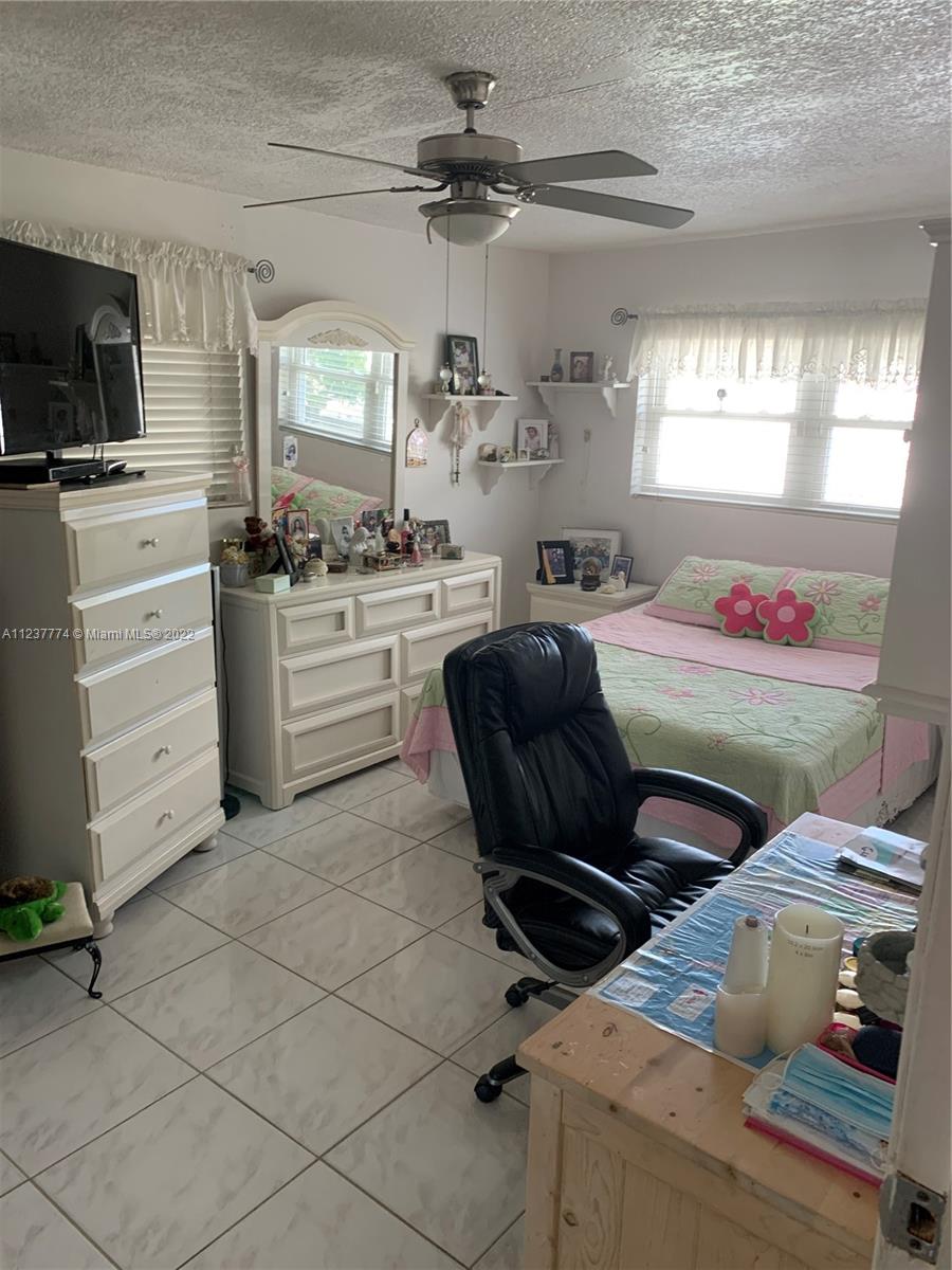 3130 Northwest 98th Street Miami, FL 33147 - Photo 4 of 23 a kitchen with a stove a sink and a refrigerator