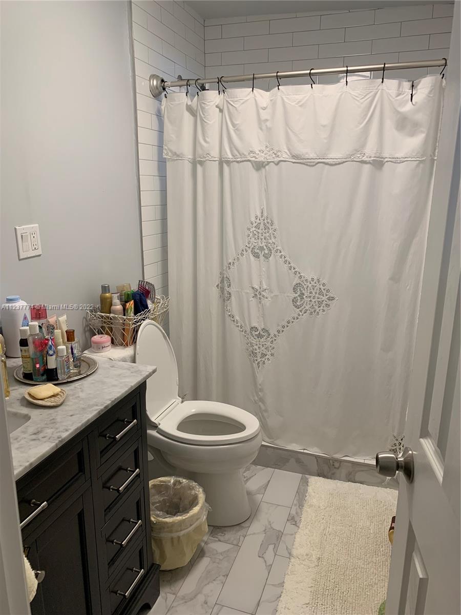 3130 Northwest 98th Street Miami, FL 33147 - Photo 5 of 23 a bathroom with a granite countertop sink toilet and a shower