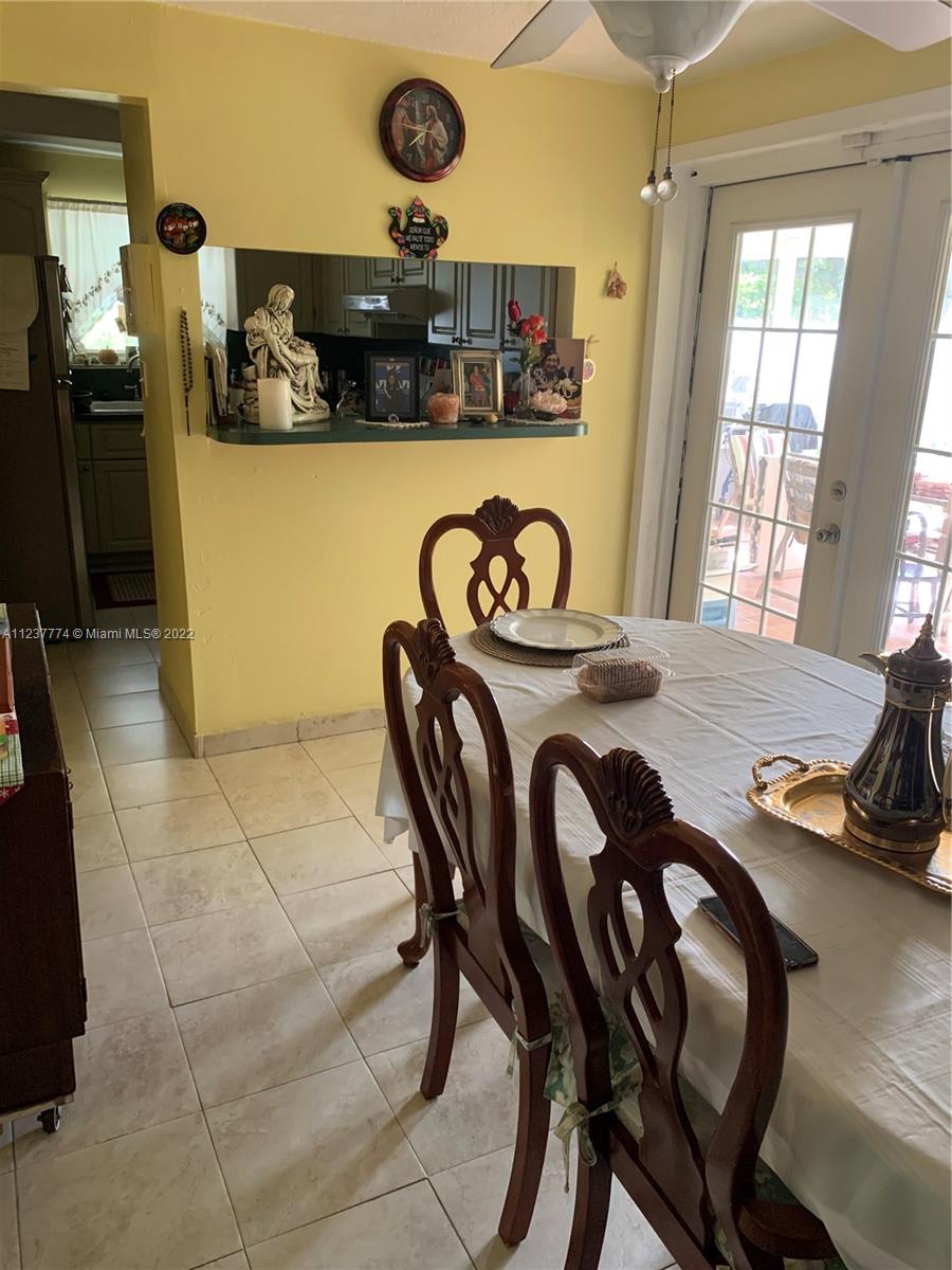 3130 Northwest 98th Street Miami, FL 33147 - Photo 7 of 23 a kitchen with a table and chairs in it