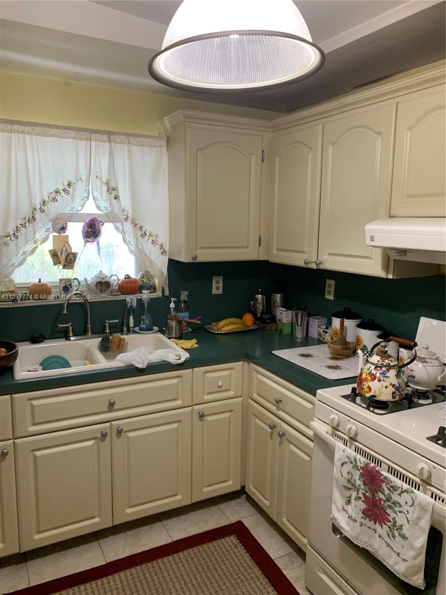 3130 Northwest 98th Street Miami, FL 33147 - Photo 8 of 23 a kitchen with a sink dishwasher and cabinets