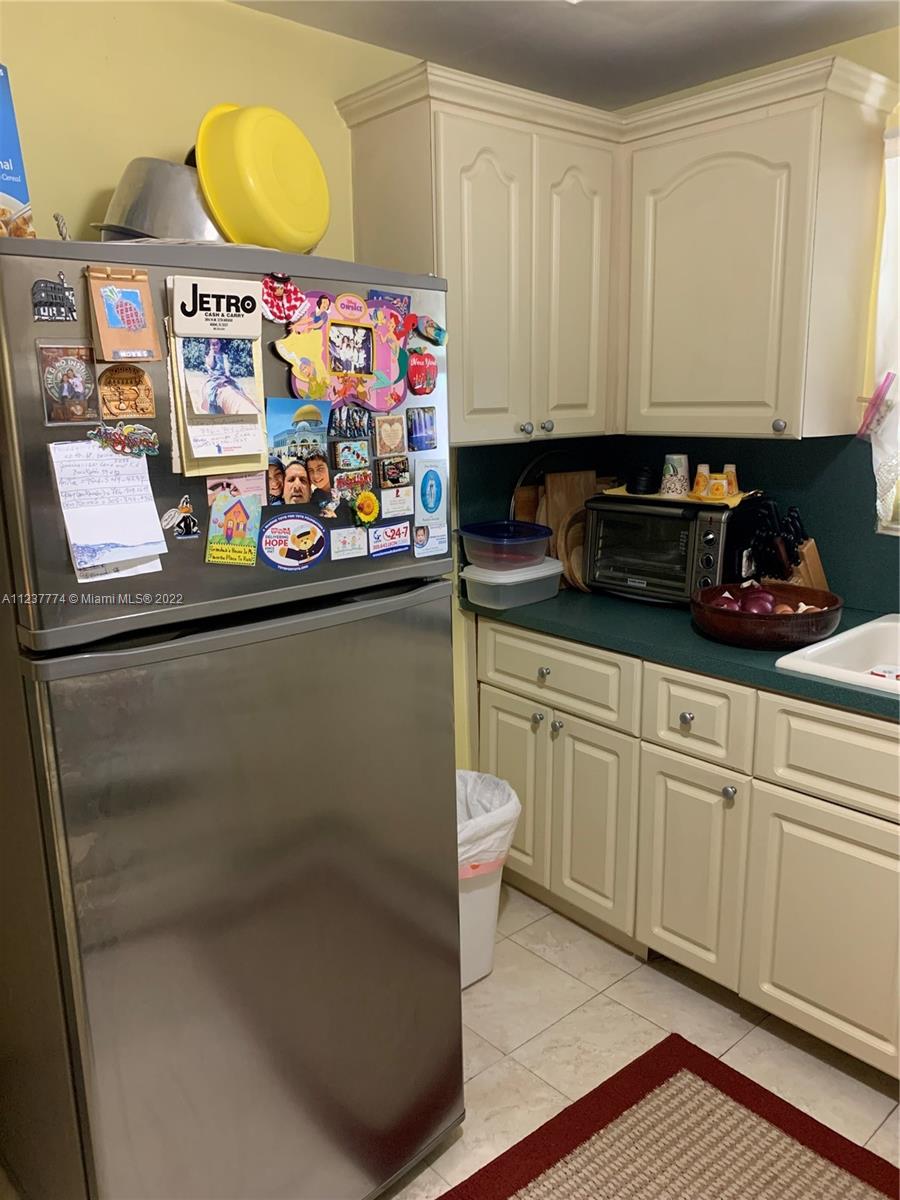 3130 Northwest 98th Street Miami, FL 33147 - Photo 9 of 23 a kitchen with stainless steel appliances granite countertop a sink and a microwave
