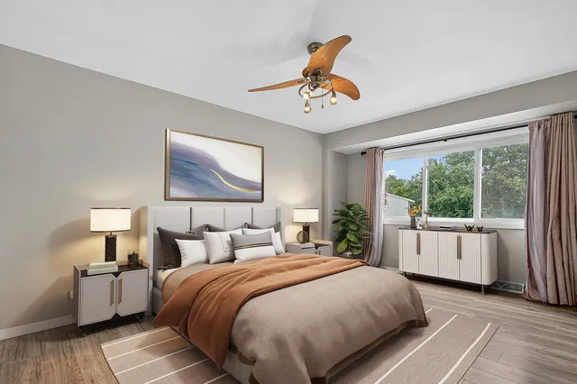 a bedroom with a large bed and a large window