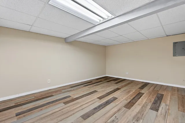 a view of empty room with wooden floor