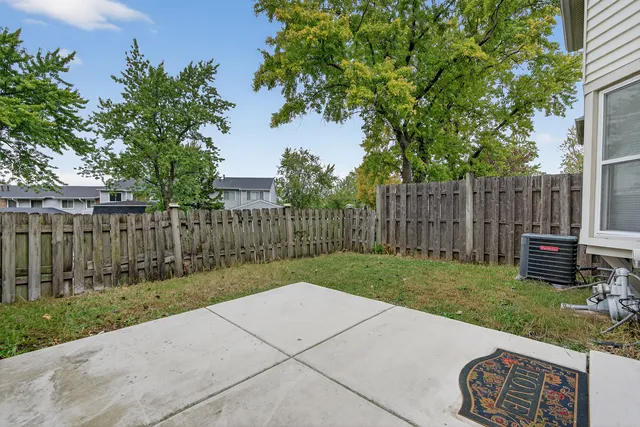 a view of a backyard with wooden fence