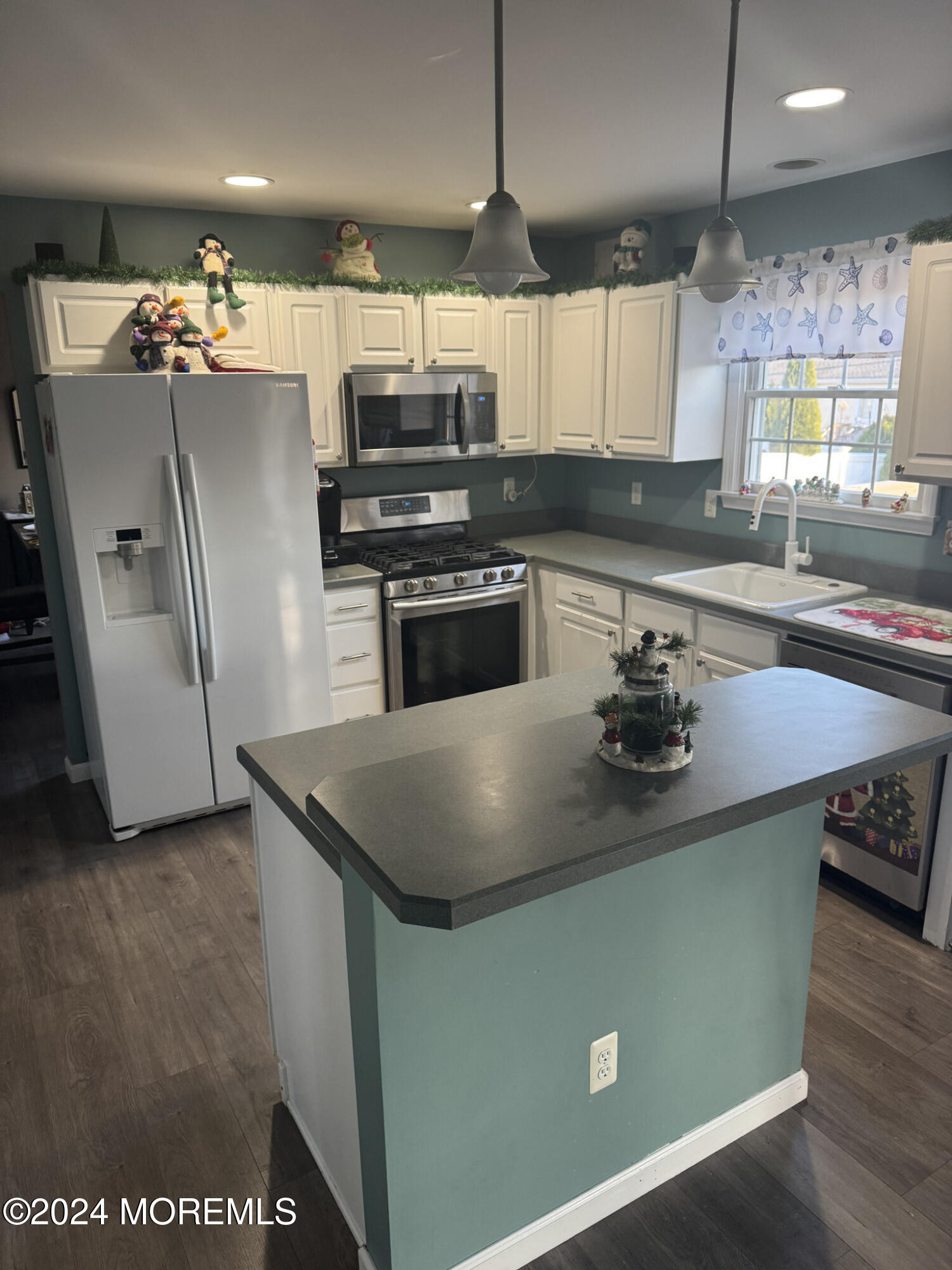 141 Marlin Road Manahawkin, NJ 08050 - Photo 11 of 33 a kitchen with stainless steel appliances granite countertop a sink a stove and a refrigerator