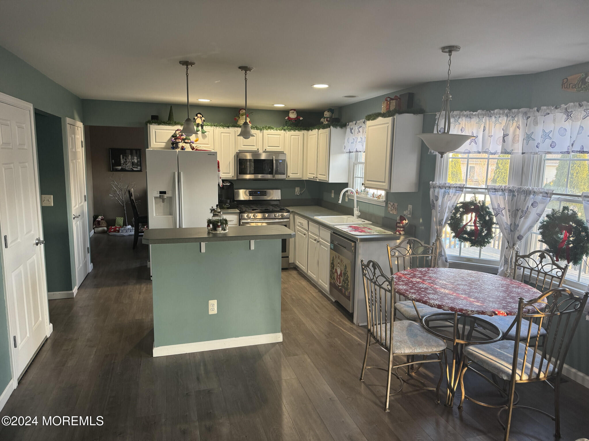 141 Marlin Road Manahawkin, NJ 08050 - Photo 15 of 33 a kitchen with kitchen island a stove a table and chairs in it