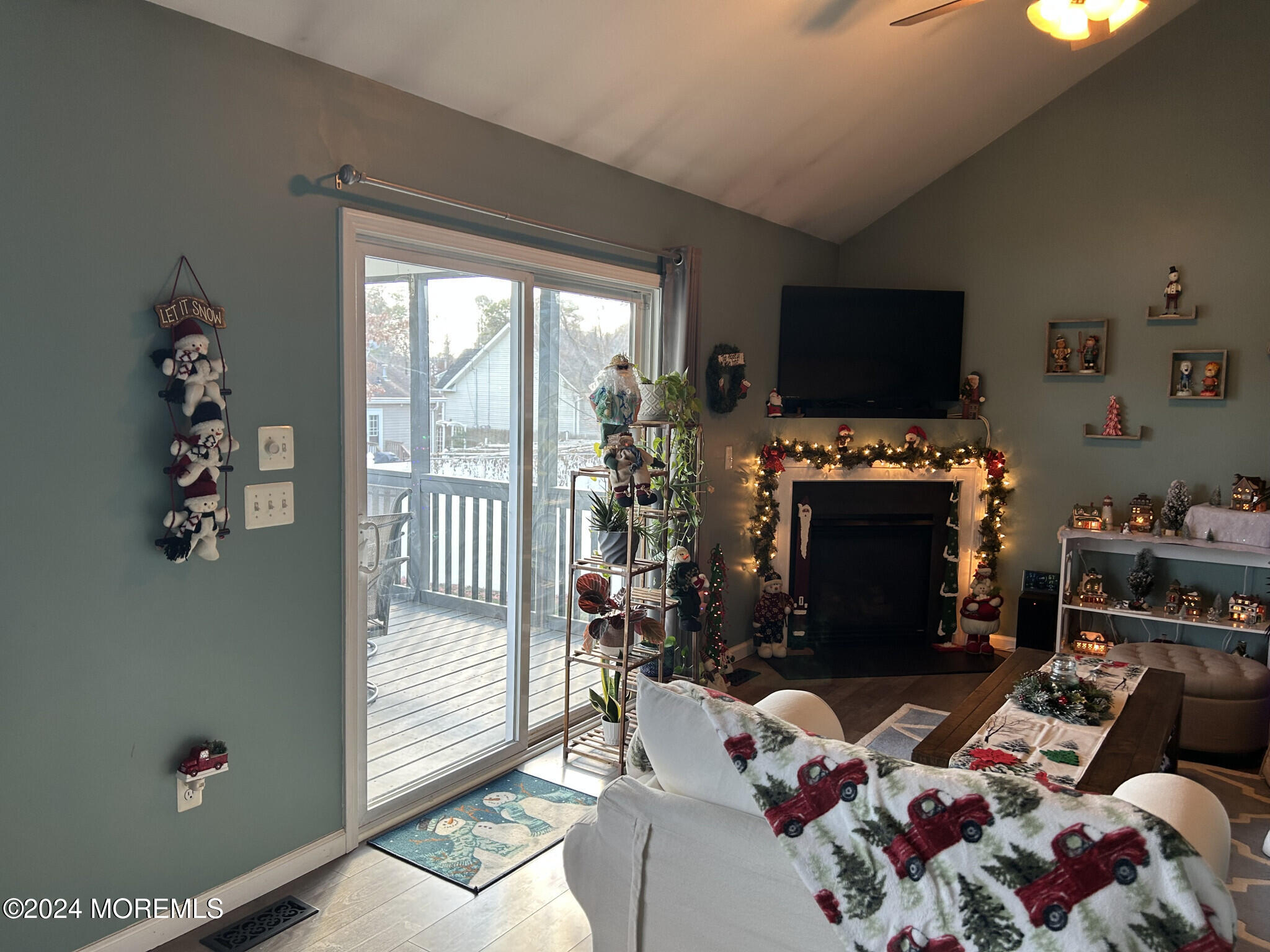 141 Marlin Road Manahawkin, NJ 08050 - Photo 16 of 33 a living room with furniture a flat screen tv and a fireplace