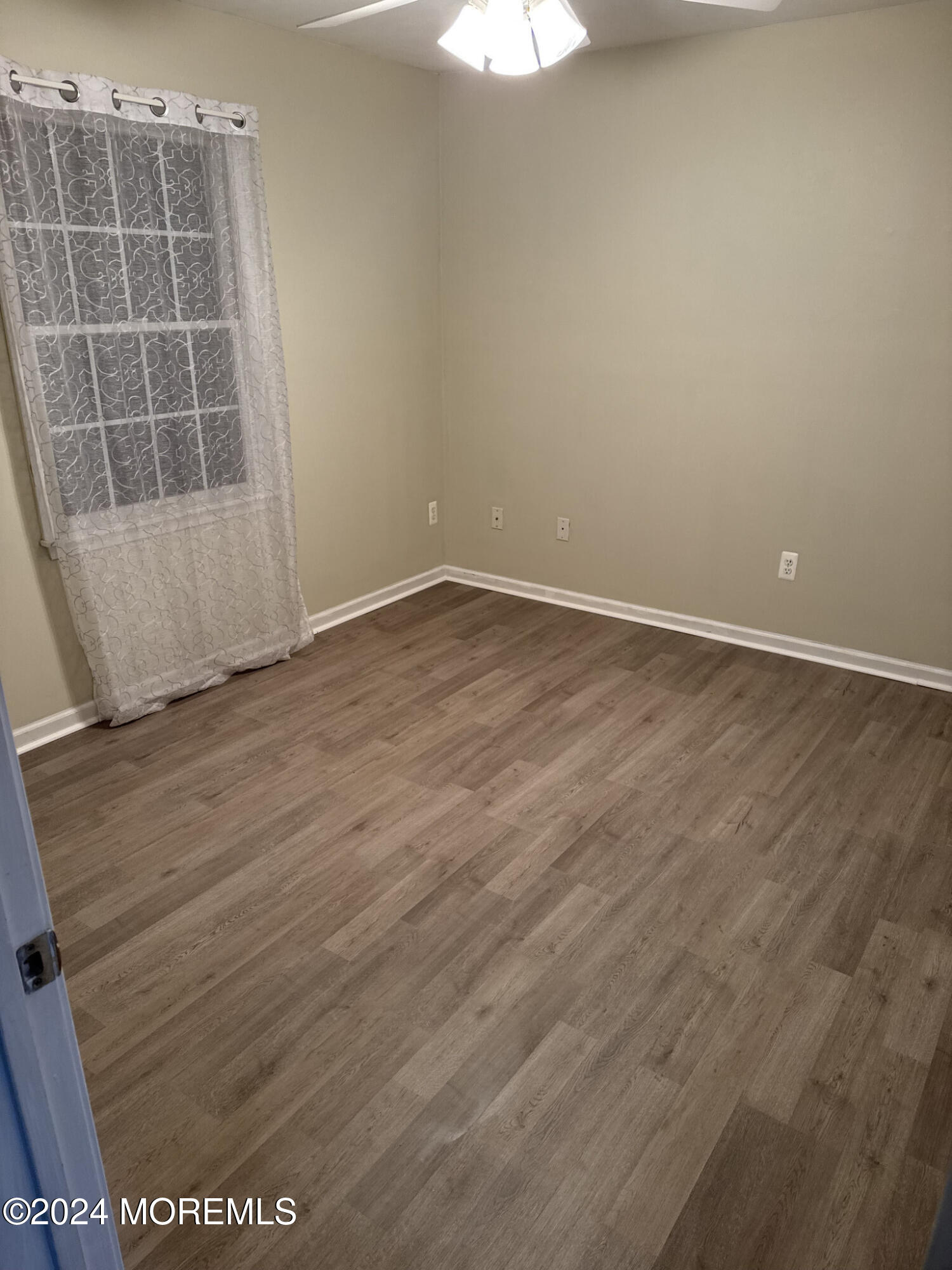 141 Marlin Road Manahawkin, NJ 08050 - Photo 29 of 33 an empty room with wooden floor and windows