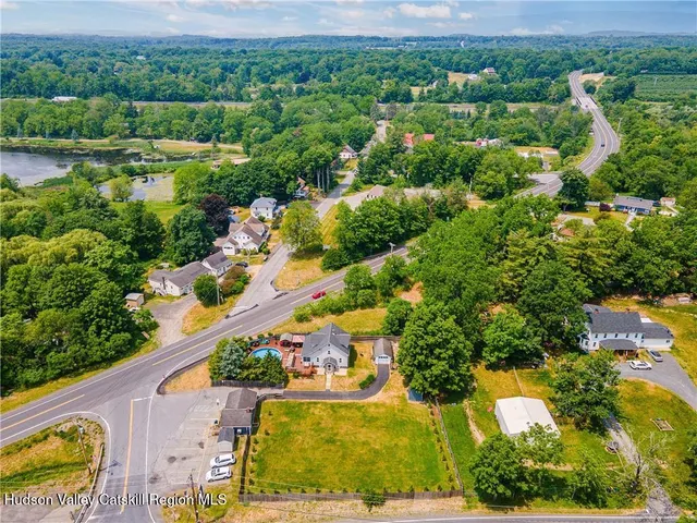 an aerial view of residential houses with outdoor space and street view