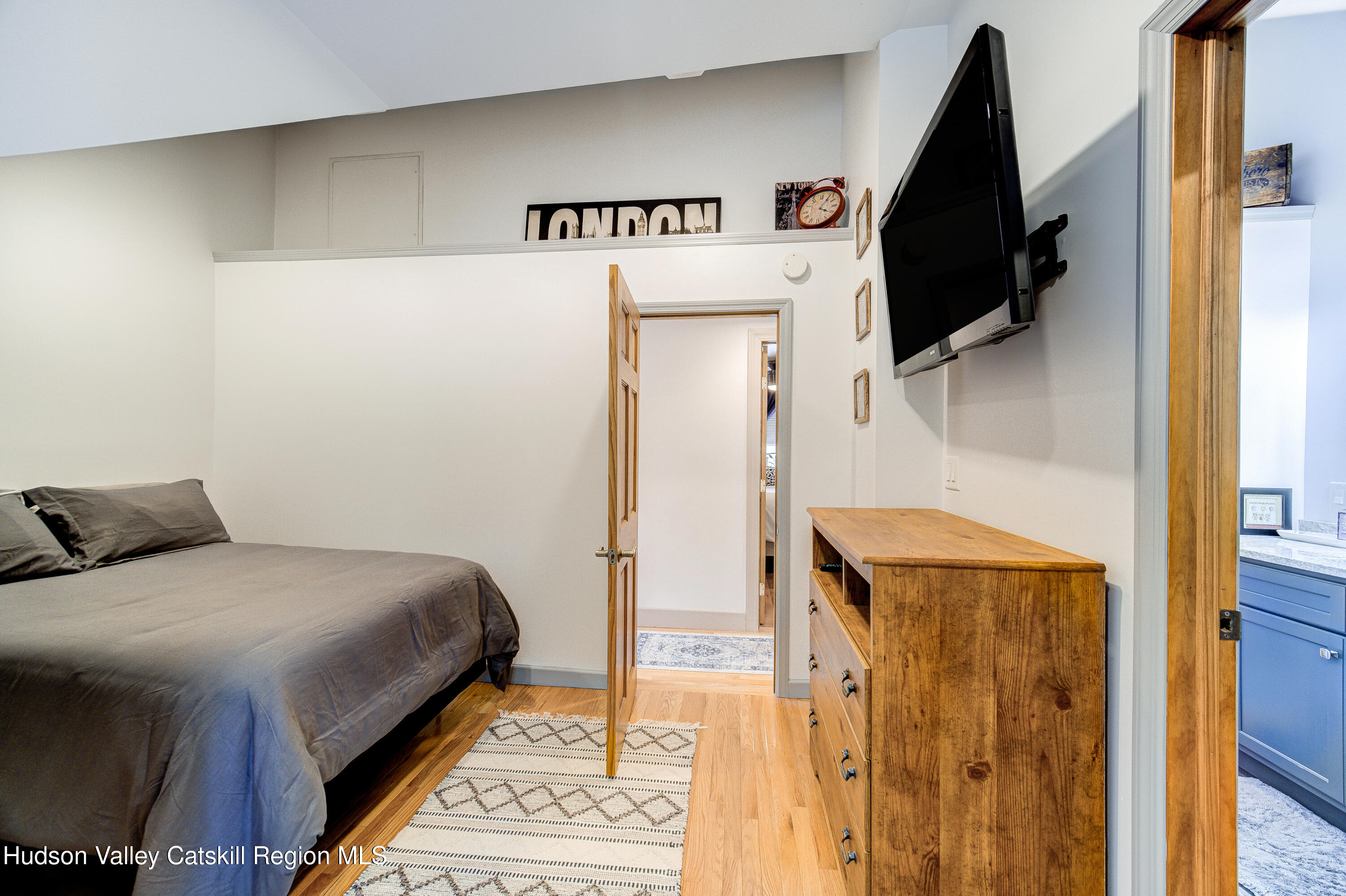 2-6 Old Firehouse Road Plattekill, NY 12589 - Photo 25 of 44 a bedroom with a bed and a flat tv screen on the wall