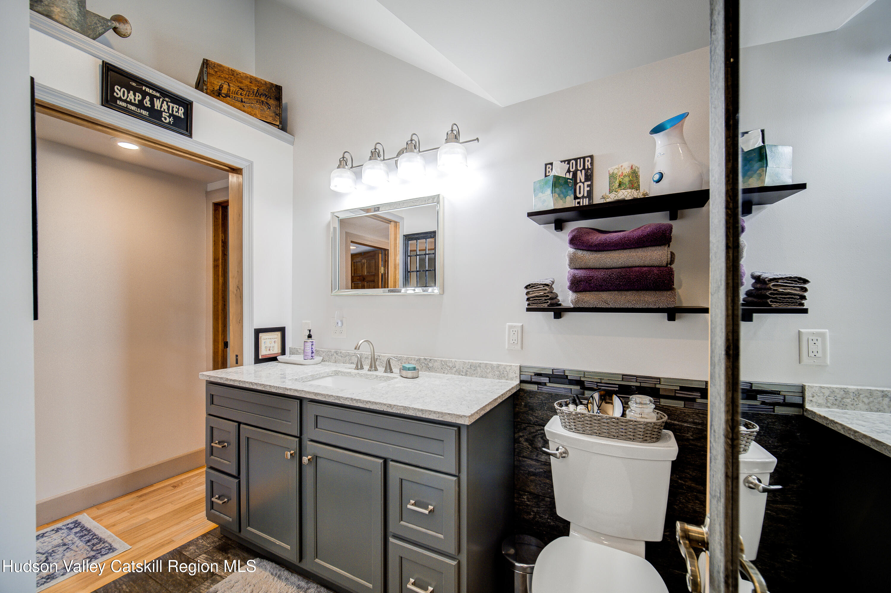 2-6 Old Firehouse Road Plattekill, NY 12589 - Photo 27 of 44 a bathroom with a toilet sink and mirror