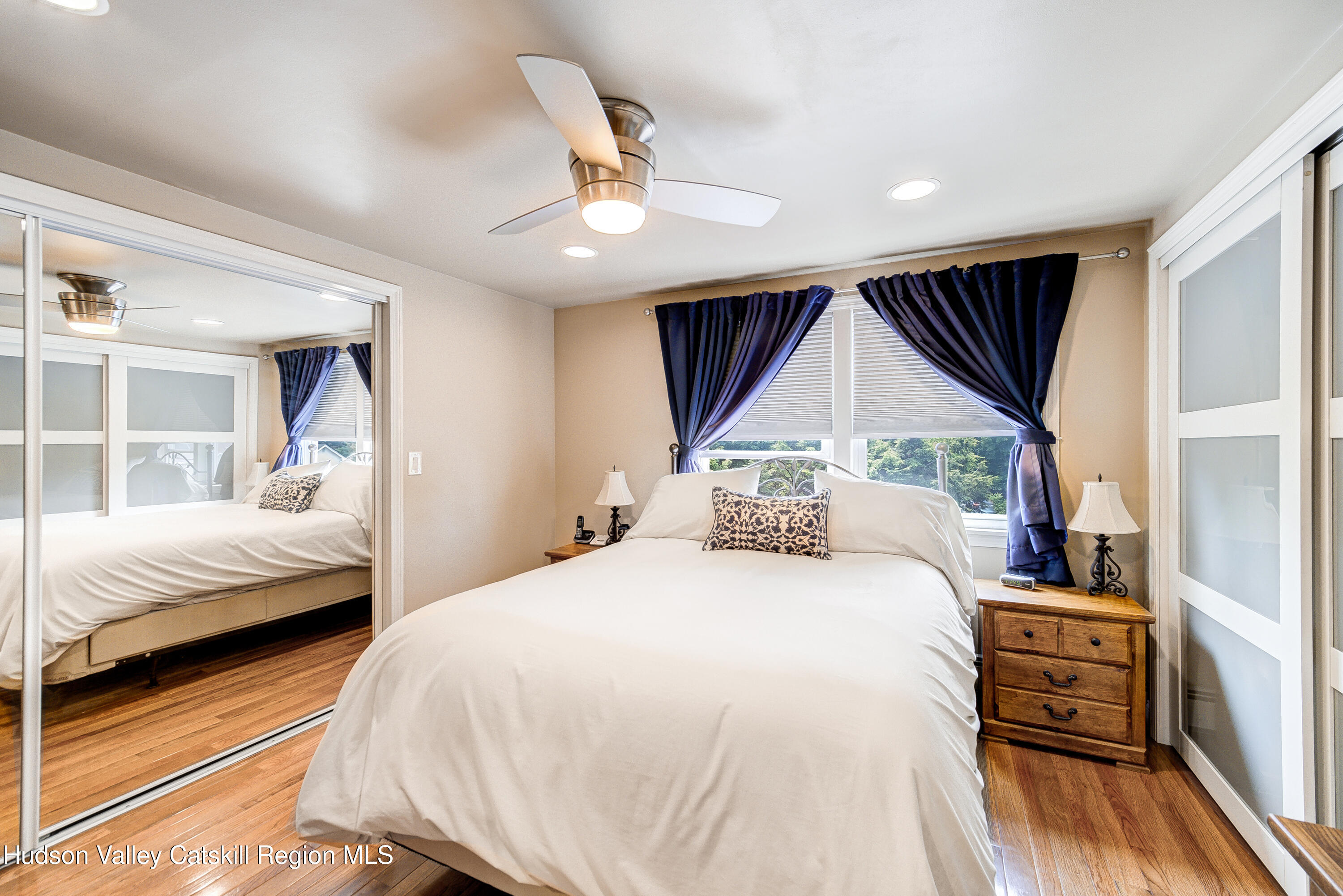 2-6 Old Firehouse Road Plattekill, NY 12589 - Photo 30 of 44 a bedroom with a bed next to a window with a flat tv screen