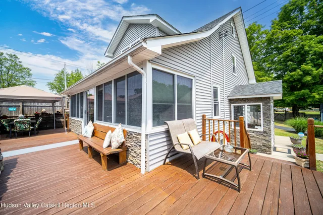 a wooden bench sitting in front of a house