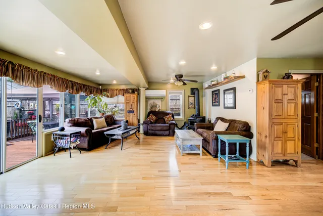 a living room with lots of furniture and a large window