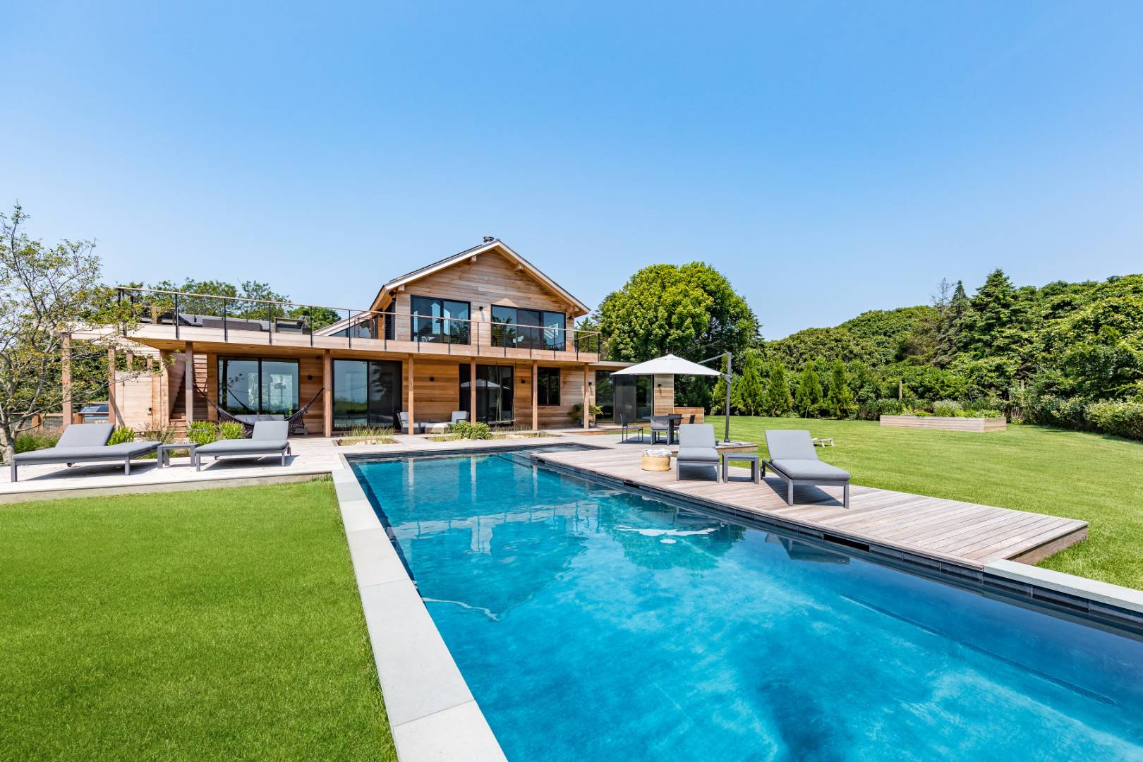 6 Tara Road Montauk, NY 11954 - Photo 2 of 24 a view of a house with swimming pool and a yard