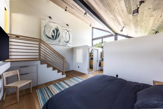 a view of a livingroom with furniture and staircase
