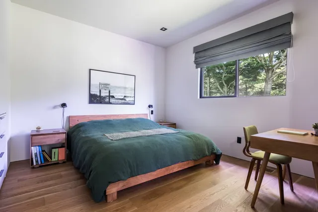 a bedroom with a bed a table and chair