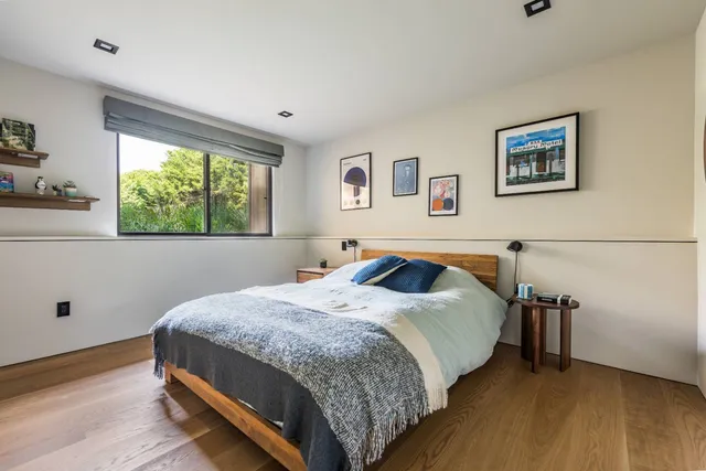 a bedroom with a bed and a window