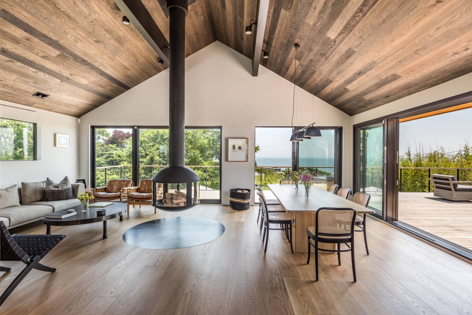 6 Tara Road Montauk, NY 11954 - Photo 4 of 24 a living room with furniture large windows and wooden floor
