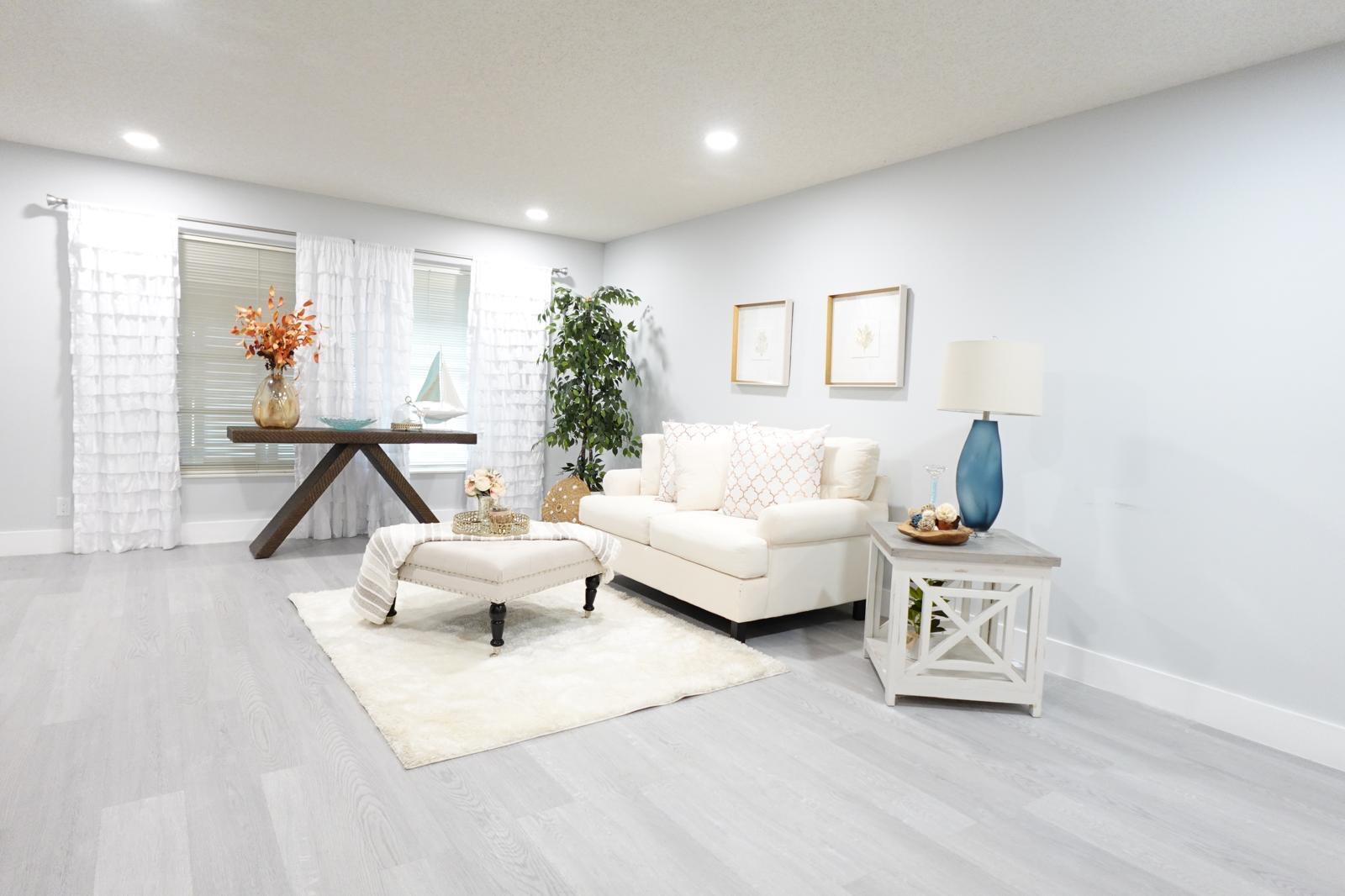 9740 Pecan Tree Drive, Unit A Boynton Beach, FL 33436 - Photo 2 of 5 a living room with furniture and a potted plant