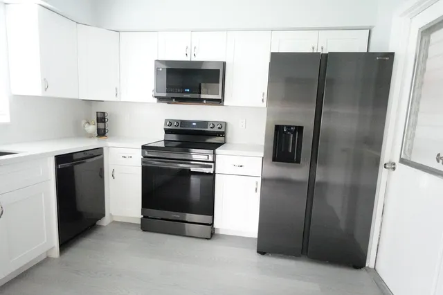 a kitchen with a refrigerator stove and microwave