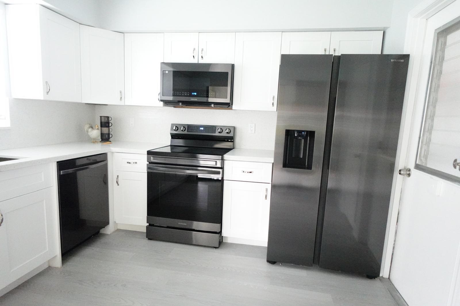 9740 Pecan Tree Drive, Unit A Boynton Beach, FL 33436 - Photo 3 of 5 a kitchen with a refrigerator stove and microwave