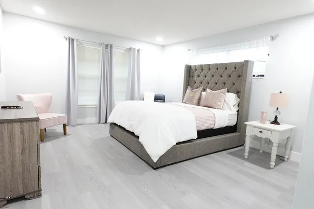 a bedroom with a bed and a table chair