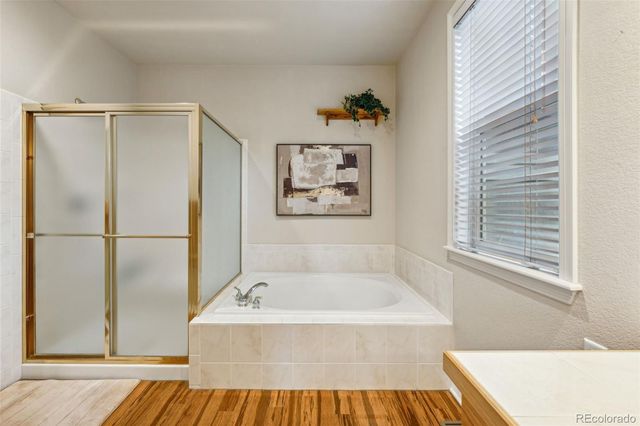 a bathroom with a bathtub and a window
