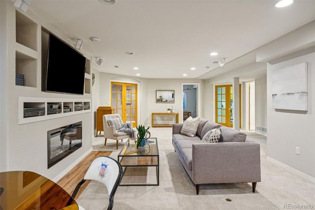 a living room with furniture flat screen tv and a fireplace