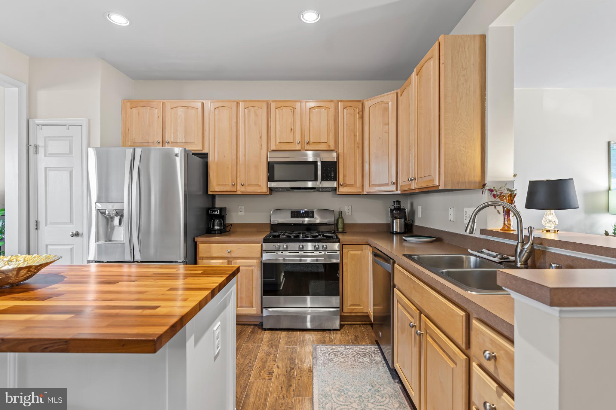 17656 Potter Bell Way Hagerstown, MD 21740 - Photo 6 of 35 a kitchen with stainless steel appliances granite countertop a stove a sink and a refrigerator