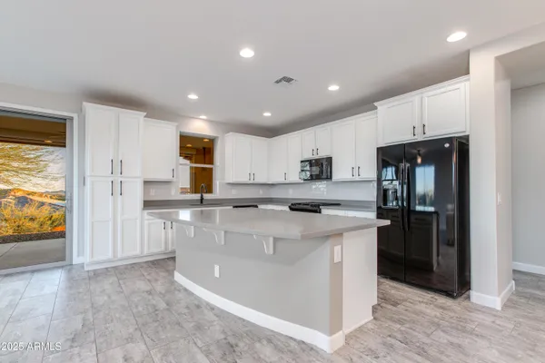 an empty room with closet and a chandelier fan