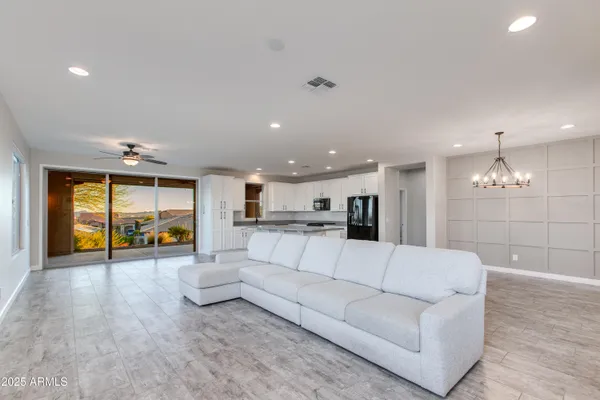 a bedroom with a large bed and a chandelier
