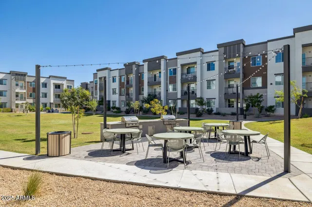 a swimming pool with outdoor seating and yard