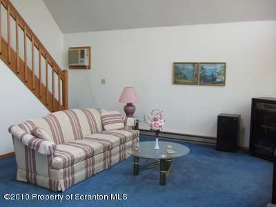 2703 Boulder Road Lake Ariel, PA 18436 - Photo 16 of 26 a living room with furniture a rug and a wall painting