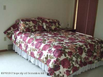 2703 Boulder Road Lake Ariel, PA 18436 - Photo 10 of 26 a bed sitting in a bedroom next to a wooden door