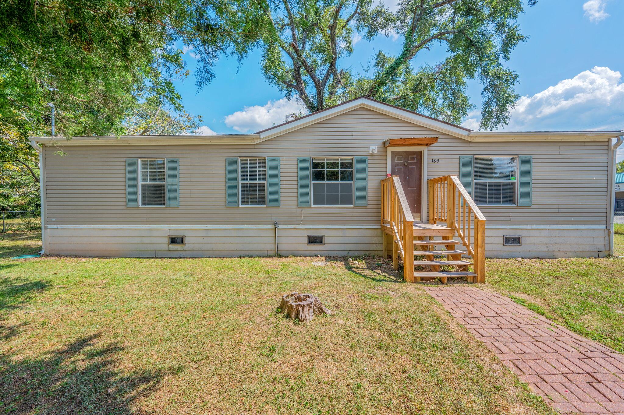 189 Benjamin Street Crestview, FL 32536 - Photo 1 of 40 a backyard of a house with barbeque oven table and chairs