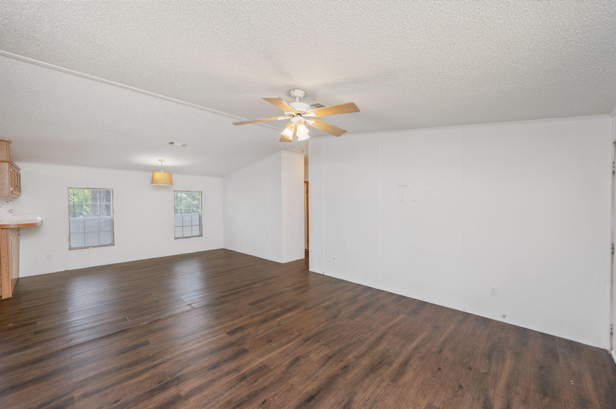 189 Benjamin Street Crestview, FL 32536 - Photo 11 of 40 an empty room with wooden floor and ceiling fan