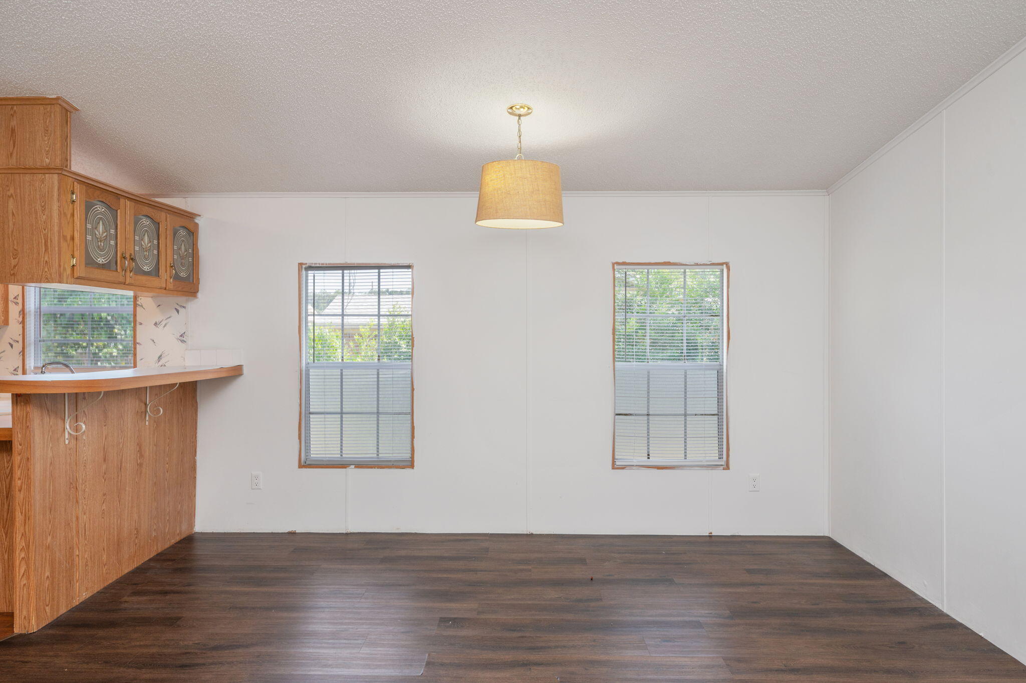 189 Benjamin Street Crestview, FL 32536 - Photo 12 of 40 a view of an empty room with wooden floor and a window
