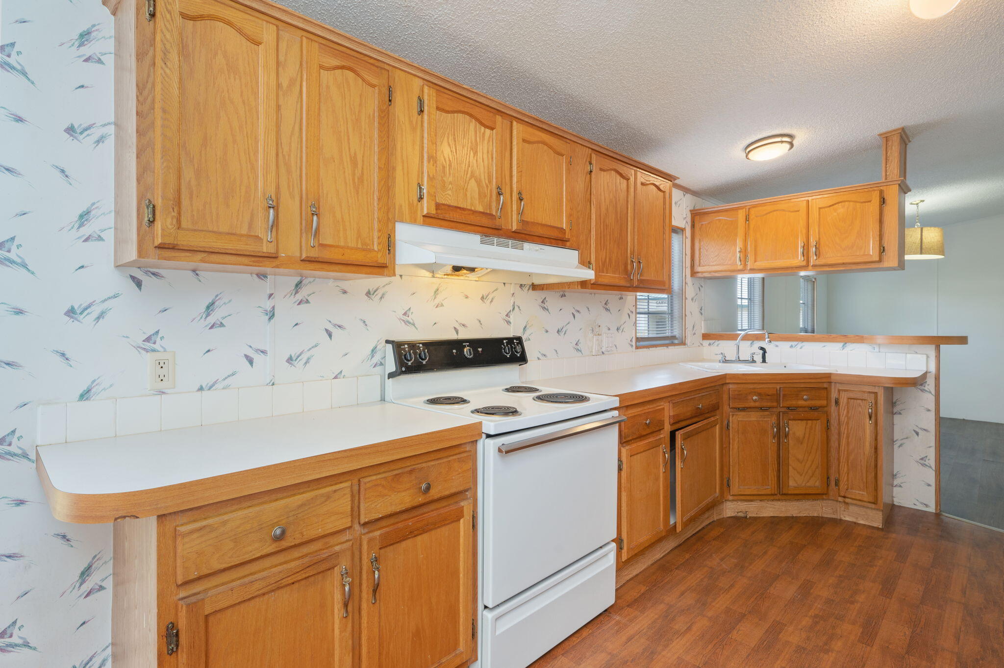 189 Benjamin Street Crestview, FL 32536 - Photo 17 of 40 a kitchen with stainless steel appliances granite countertop a sink dishwasher stove and cabinets