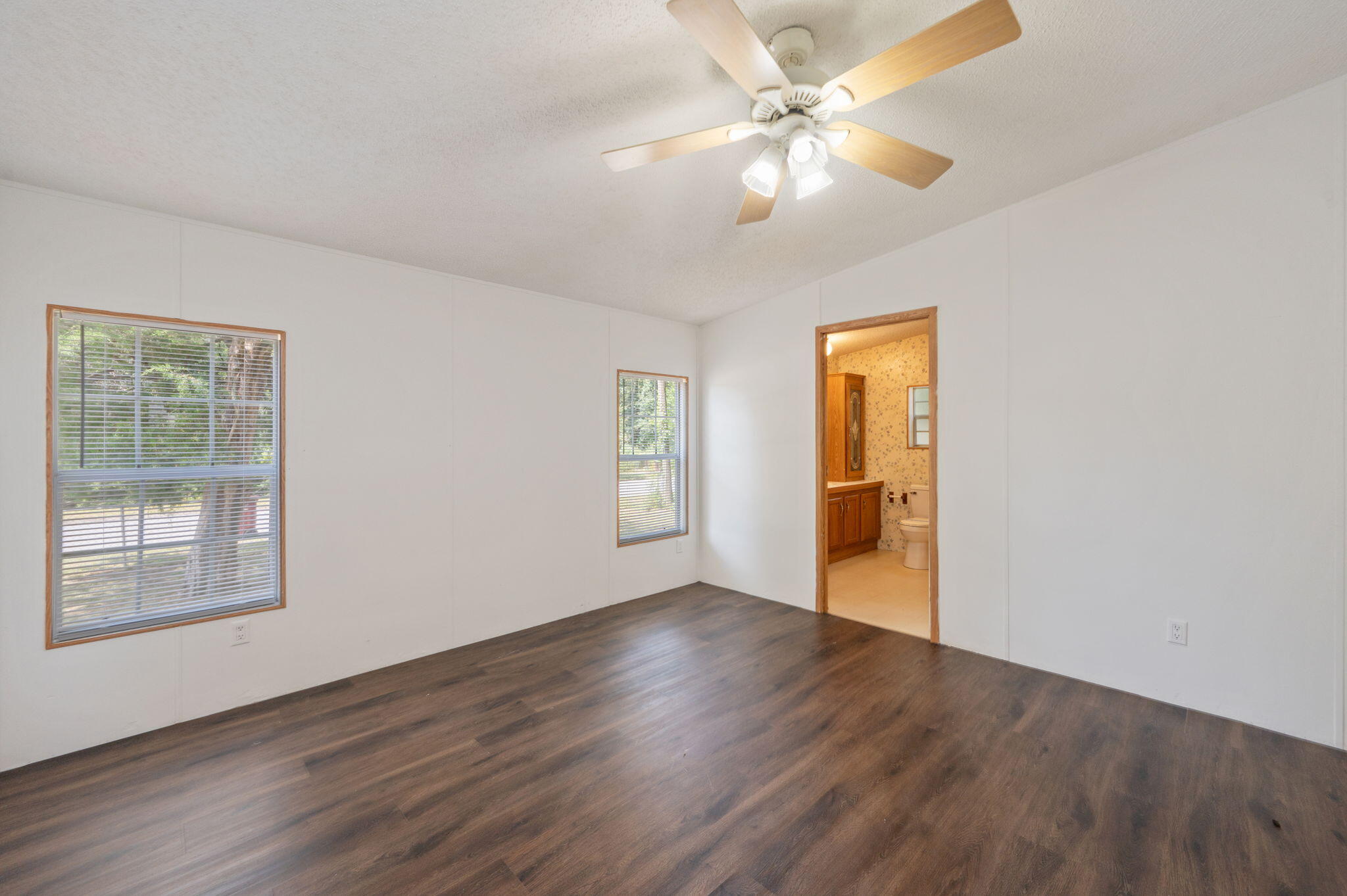 189 Benjamin Street Crestview, FL 32536 - Photo 20 of 40 a view of an empty room with window and wooden floor