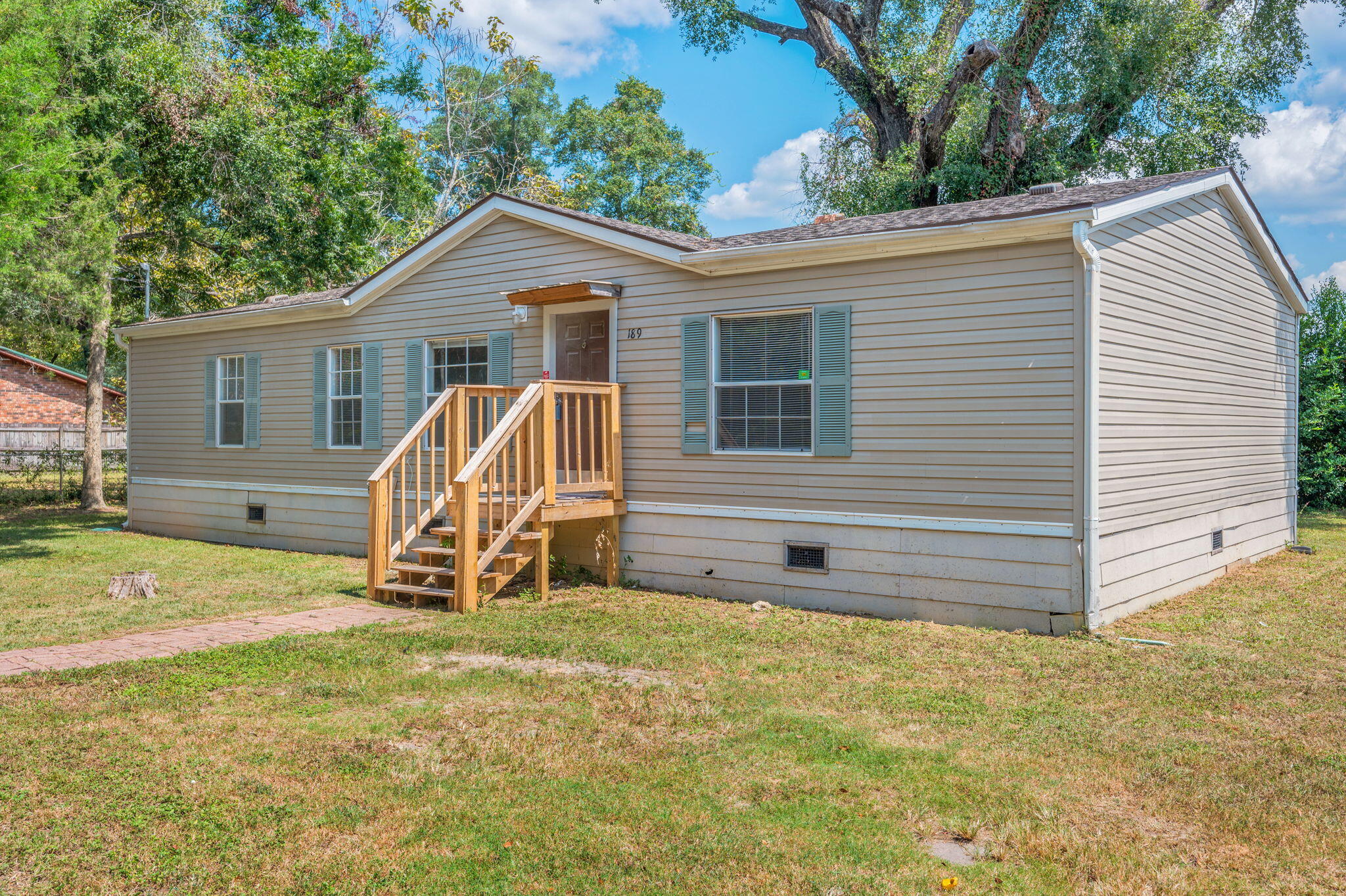 189 Benjamin Street Crestview, FL 32536 - Photo 2 of 40 a view of a house with backyard and a tree