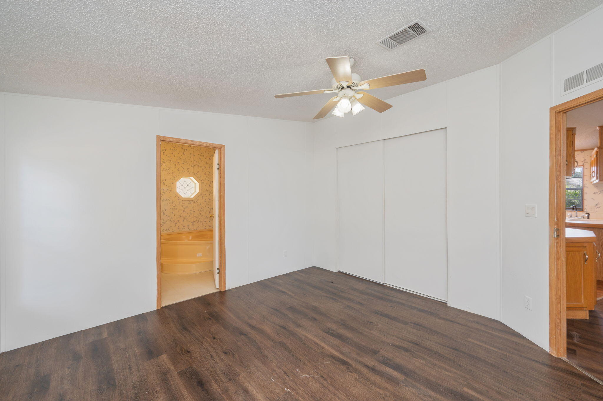 189 Benjamin Street Crestview, FL 32536 - Photo 21 of 40 a view of empty room with wooden floor and fan